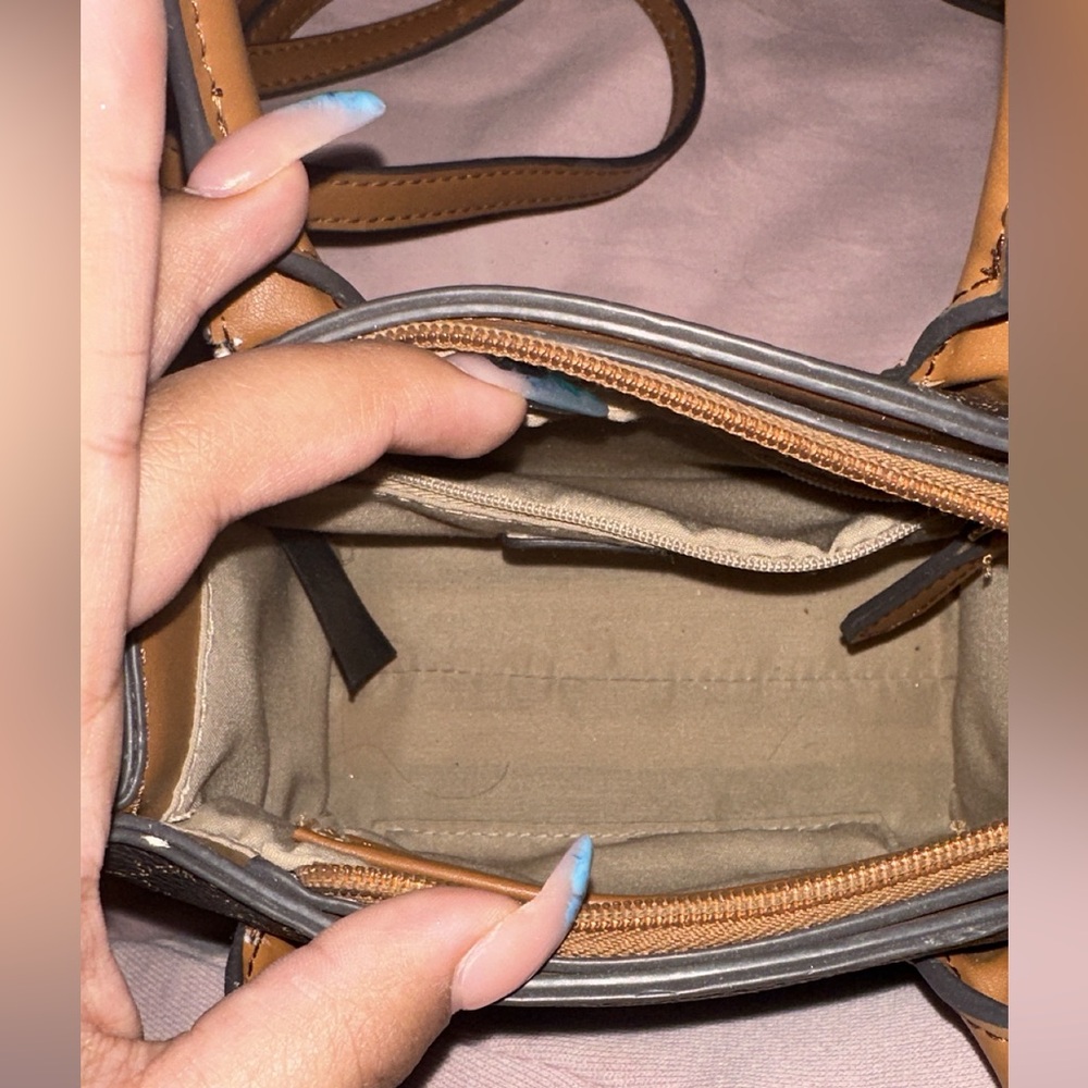Brown and black mini purse that is crossover